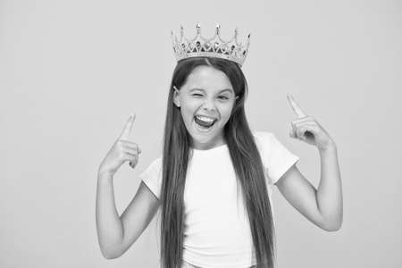 she is big boss. proud of her reward. luxury and success. selfish little girl wear golden crown. small princess kid. feel like champion. happy childhood. good motivation conceptの写真素材