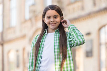 Treat your hair today. Happy girl wear long hairstyle. Hair salon. Kids barber. Beauty salon. Salon haircare. Hair cosmetic products. My hair needs a hairdresserの写真素材