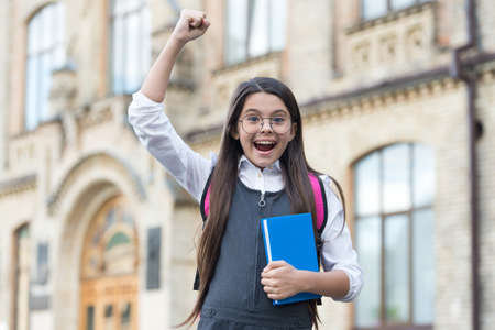 Yes, we make winners. Happy winner outdoors. Small kid make winning gesture. Scholarship winner. Success in study. Back to school. Formal education. Knowledge day. September 1. You can do itの写真素材
