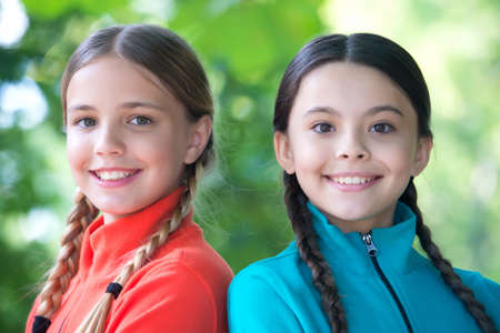 Girls friends fleece clothes for active leisure nature background, scouts camp conceptの写真素材
