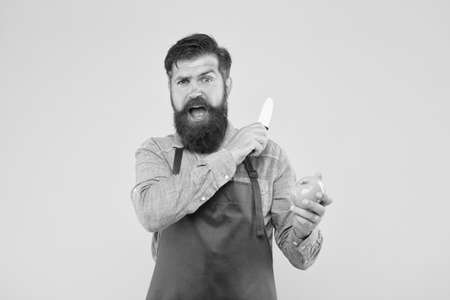 Mature man hold knife and vegetable. Chef prepares meal. Safe cutting. Cutting veggies. Ultimate list of cutting techniques every chef should know. Bearded man prepare tomato. Fresh salad recipeの写真素材