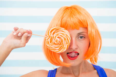 Crazy girl in candy shop. Pretty girl with lollipop in sweet shop. Crazy about candies. sexy gwoman...