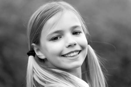 Little girl smile on natural background, childhood