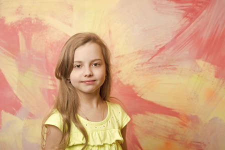 small baby girl with adorable face in yellow shirtの写真素材