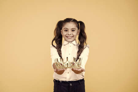 Beautiful princess. Just best. Princess life. Symbol of luxury. Small princess. Queen of class. School competitions concept. Adorable small child crowned champion girl. Happy little winner coronationの写真素材