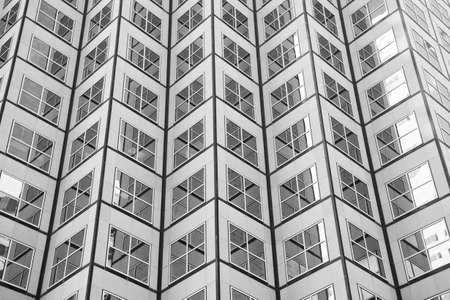 Bewitching pattern of windows. Skyscraper modern city architecture. Modern building architecture. Sky reflects in mirror glass windows. Architecture concept. Business centre. Abstract backgroundの写真素材