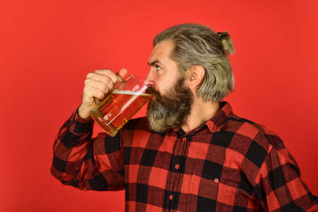 Mature bearded man hold beer glass.の写真素材