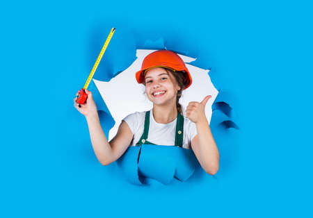 Real professional. growing concept. little girl with measuring tape. instruments for renovation...