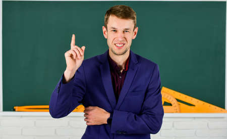 Teacher introduced to class young man at chalkboard, education reforms conceptの写真素材