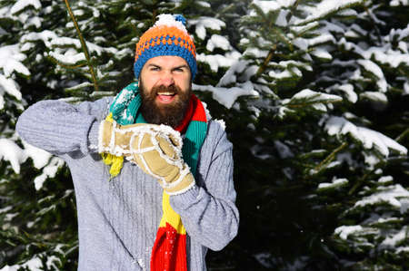 Guy with happy face with firtrees covered with snow