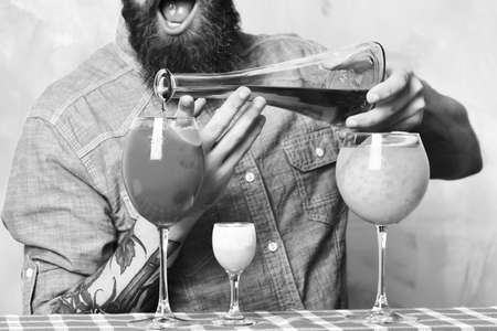 Brutal caucasian hipster with alcoholic cocktails and bar stuffの写真素材