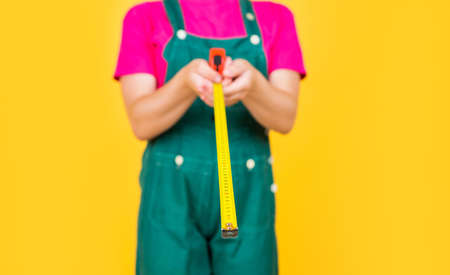 concept of repair. Little girl using a measuring tape. engineer. child hold tape measure. kid...