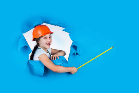 engineer. happy child hold tape measure. kid builder wear helmet. teen girl in hard hat and uniform....