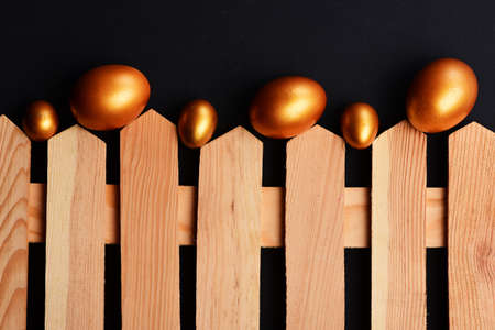 traditional eggs painted in golden color on fenceの写真素材