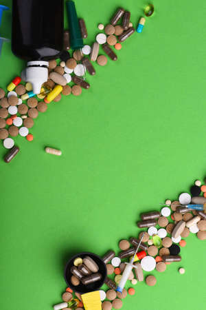 Drugs near syrup bottle, syringes and measuring spoonの写真素材