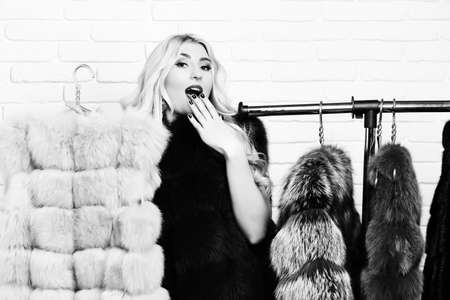 fashionable sexy woman in fur on brick wall studio background