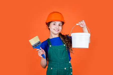 small painter hold paint bucket and brush. paint wall in color.の写真素材