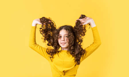 Little child curly hair. Fashion and beauty. Professional cosmetics.