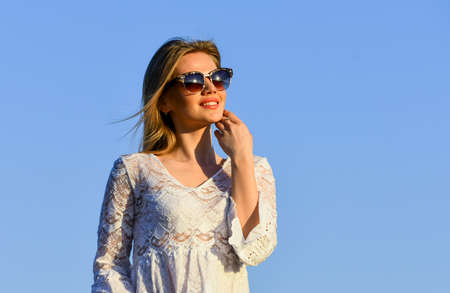 Pretty woman fashionable sunglasses outdoors. Girl white dress feel free.の写真素材