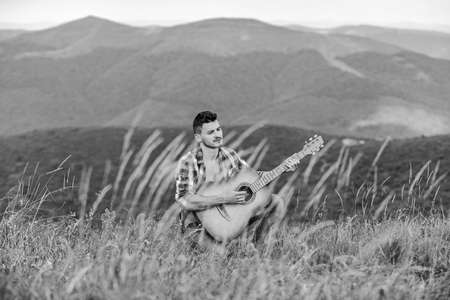 acoustic guitar player. country music song. sexy man with guitar in checkered shirt.の写真素材