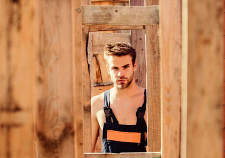 Handsome builder at construction site. Guy works at constructionの写真素材