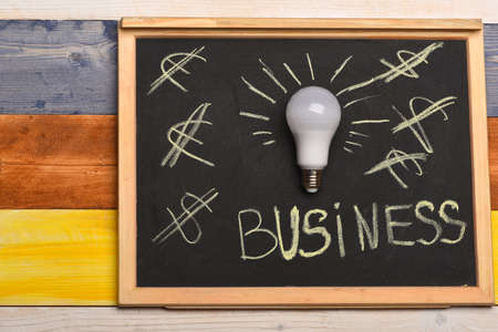 Chalkboard with idea lamp near dollar and euro signsの写真素材