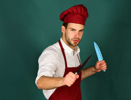 Kitchenware and cooking concept. Cook works in kitchen.