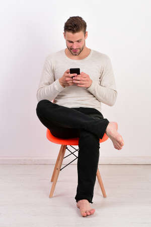 Youth and technology concept. Man with stylish hair and interestedの写真素材