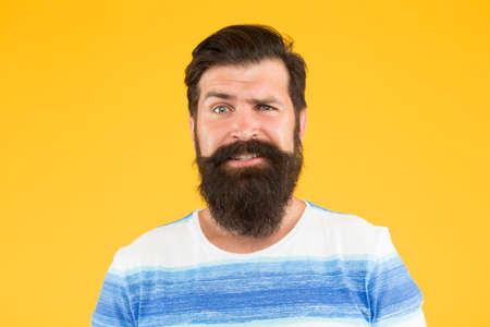 Emotional intelligence. Man bearded stylish beard yellow background. Barber services. Hairdresser salon. Fancy mustache. Male portrait. Barber tips. Beard and mustache. Hipster style. Beard fashionの写真素材