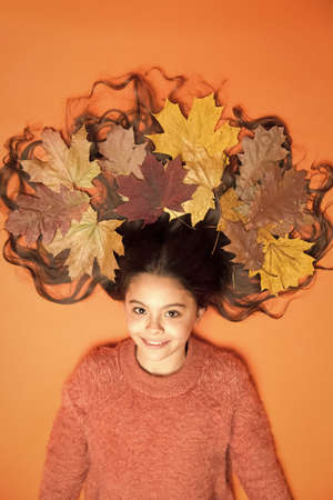 Leafy hairstyle. Small girl wear autumn foliage in curly hairstyle. Best autumn hairstyle. Creating...