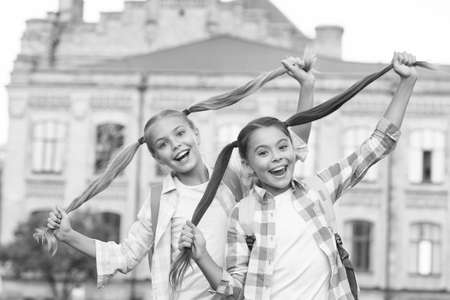 Carefree playful children. Summer learning ideas for kids. Happiness and joy. Smiling friends having fun at school yard. Happy schoolmates. School camp. Modern education. Girls school backgroundの写真素材