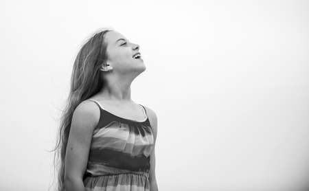 Happy international childrens day. Happy childhood. Cute little girl in summer dress outdoors sky background. Happy vacation. Enjoying relax. Child happy small girl. Free and carefree. Good vibesの写真素材