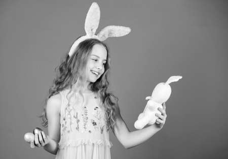 Child cute bunny costume. Happy easter. Playful baby celebrate easter. Spring holiday. Happy childhood. Ready for Easter day. Easter activities for children. Holiday bunny girl with long bunny earsの写真素材