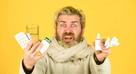 Man with pills and nasal spray. cough cold and runny nose remedy. coronavirus from china. suffering from insomnia. Health and medicine. use of antidepressant. male self treatment. selective focusの写真素材