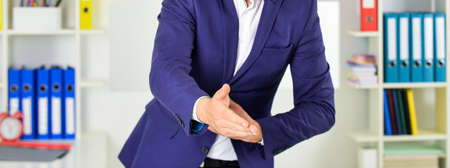 Nice to meet you. Welcome. Take a sit. Hello gesture. Lend a hand. Hospitable people. Good manners. Extend hand in welcome gesture. Smart and intelligent. Businessman welcoming guest. Thank youの写真素材