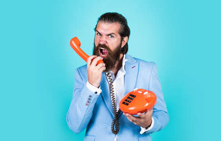 be somewhat more techy. businessman talking on vintage phone. Male talking on landline phone....