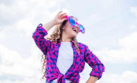 kid fashion style. teenage girl on sky background outdoor. hipster kid. happy childrens day. happy...
