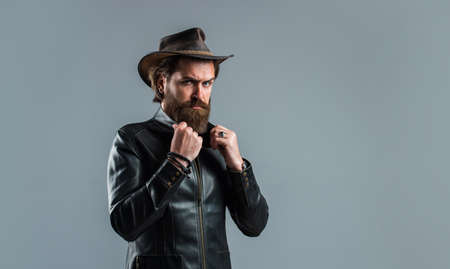 Brutal man cowboy hat leather jacket, ranch and farming conceptの写真素材