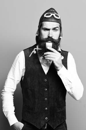 serious handsome bearded pilot on blue studio backgroundの写真素材