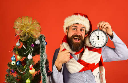 Christmas gifts and time concept. Santa near decorated fir tree