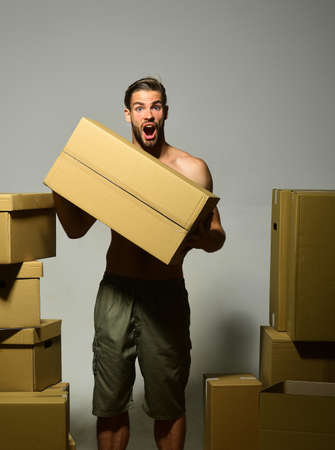 Man with beard stands on dark grey background.の写真素材