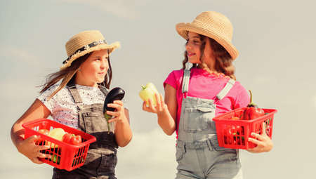 It is for you. children farming. autumn harvest. healthy food is happy life. small girls vegetable in basket. Only natural. harvest vitamin. spring market garden. kids on summer farm. Organic foodの写真素材