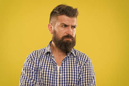 Hipster appearance. Beard fashion and barber concept. Man bearded rustic hipster stylish beard yellow background. Barber tips maintain beard. Stylish beard and mustache care. Bearded and confidentの写真素材