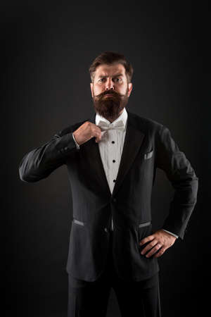 Hipster formal suit tuxedo. Difference between vintage and classic. Official event dress code. Classic style. Menswear classic outfit. Bearded man with bow tie. Well dressed and scrupulously neatの写真素材