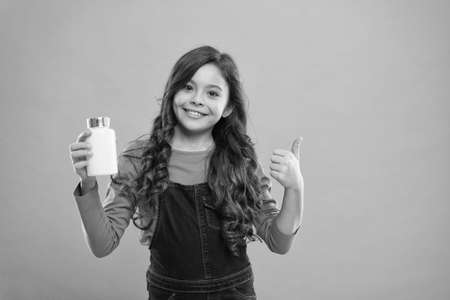 For teeth and bones. Daily amount of nutrients. Little cute child going to take vitamin. Food additives. Pills for kids. Vitamin and mineral complex. Medicine concept. Boost immunity. Best vitaminsの写真素材