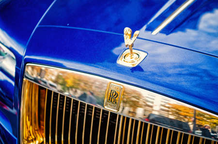 luxury Supercar rolls royce rolls-royce ghost blue and gold color parked on the street in Paris....