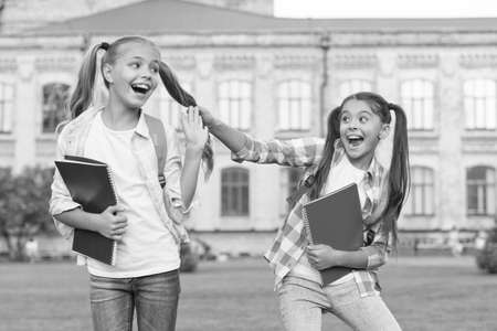 Happy schoolmates. School camp. Modern education. Teens with backpacks. Girls school background. STEM summer camps and courses for kids. Happiness and joy. Smiling friends having fun at school yardの写真素材