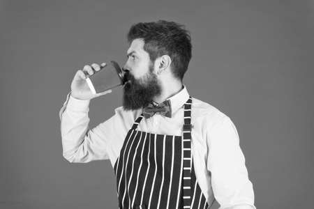 More coffee. serious barista drink big latte. professional waiter or barkeeper serve coffee. brutal coffee maker. portrait of bearded barista standing in cafe. barista handsome workerの写真素材