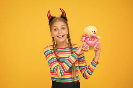 Small demon. Playful demon girl. Little demon inside. Girlish temper. Cute but dangerous. Halloween concept. Small adorable child with red horns. Accessories for carnival. Preparing for partyの写真素材