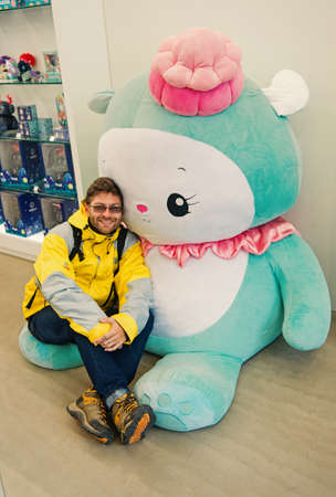 Reykjavik, Iceland - October 12, 2017: man traveler with hello kitty toy. Leisure traveler man....